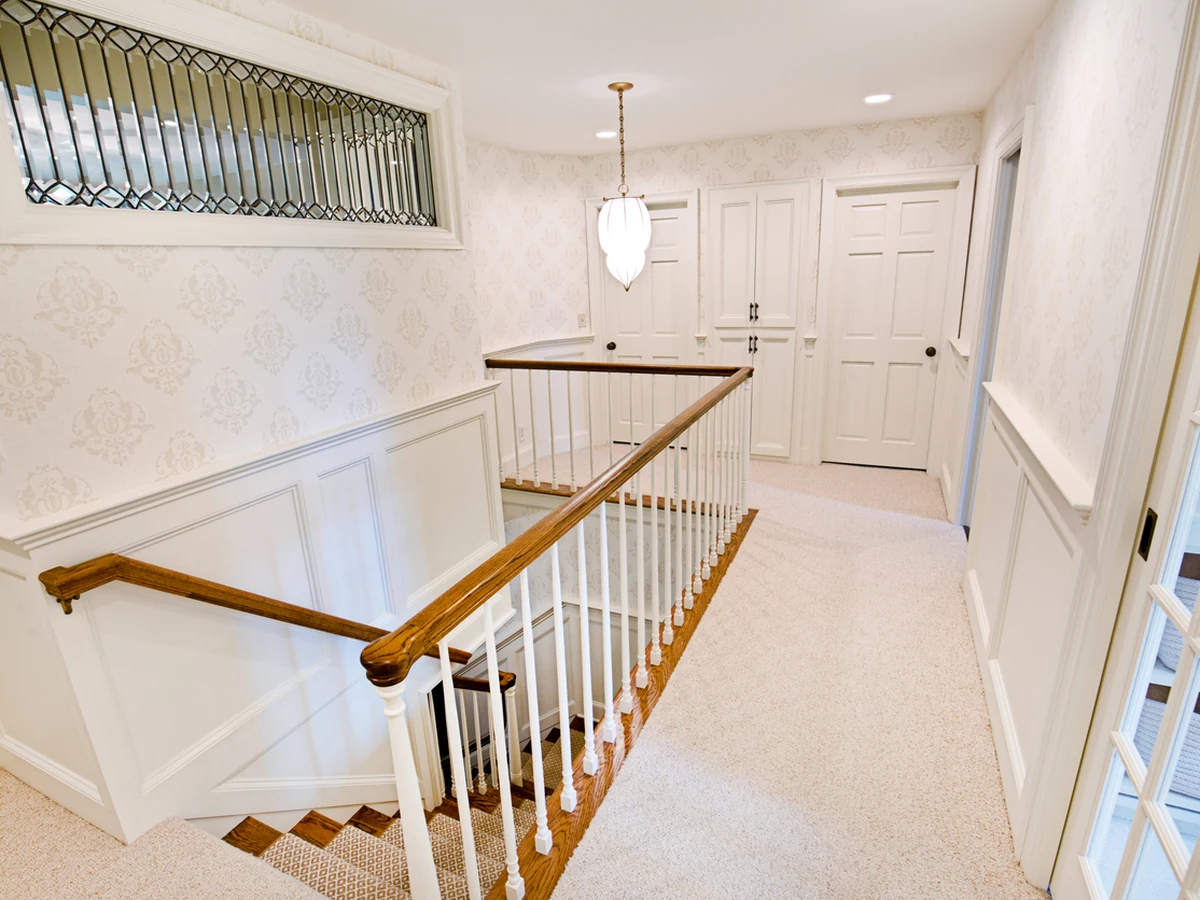 Residential stairwell staircase painting in white by Harrogate Decorators