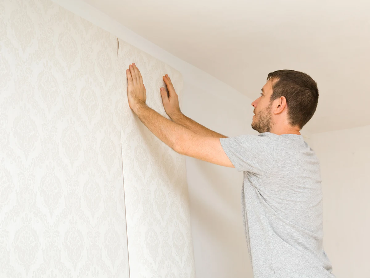 wallpapering-man-pressing-patterned-harrogate-decorators Decorator pressing patterned wallpaper in Harrogate, Harrogate Decorators